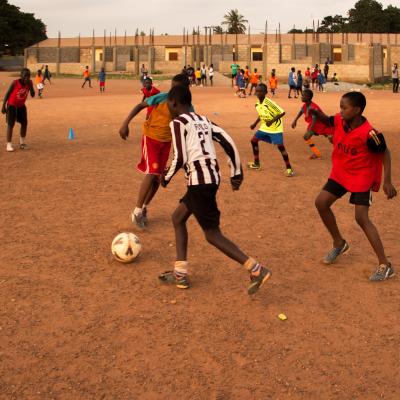 A Projects Abroad volunteer work with teens to teach football in Ghana. A sports player gains experience through volunteer football coaching in Ghana.